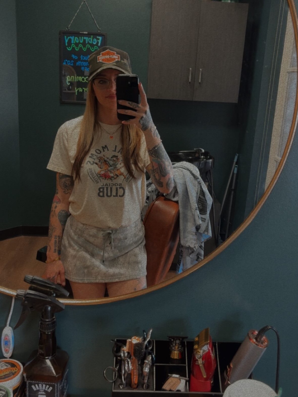Rachel Trammell in her suite at Phenix Salon Suites, with the round brass mirror and her tool tray